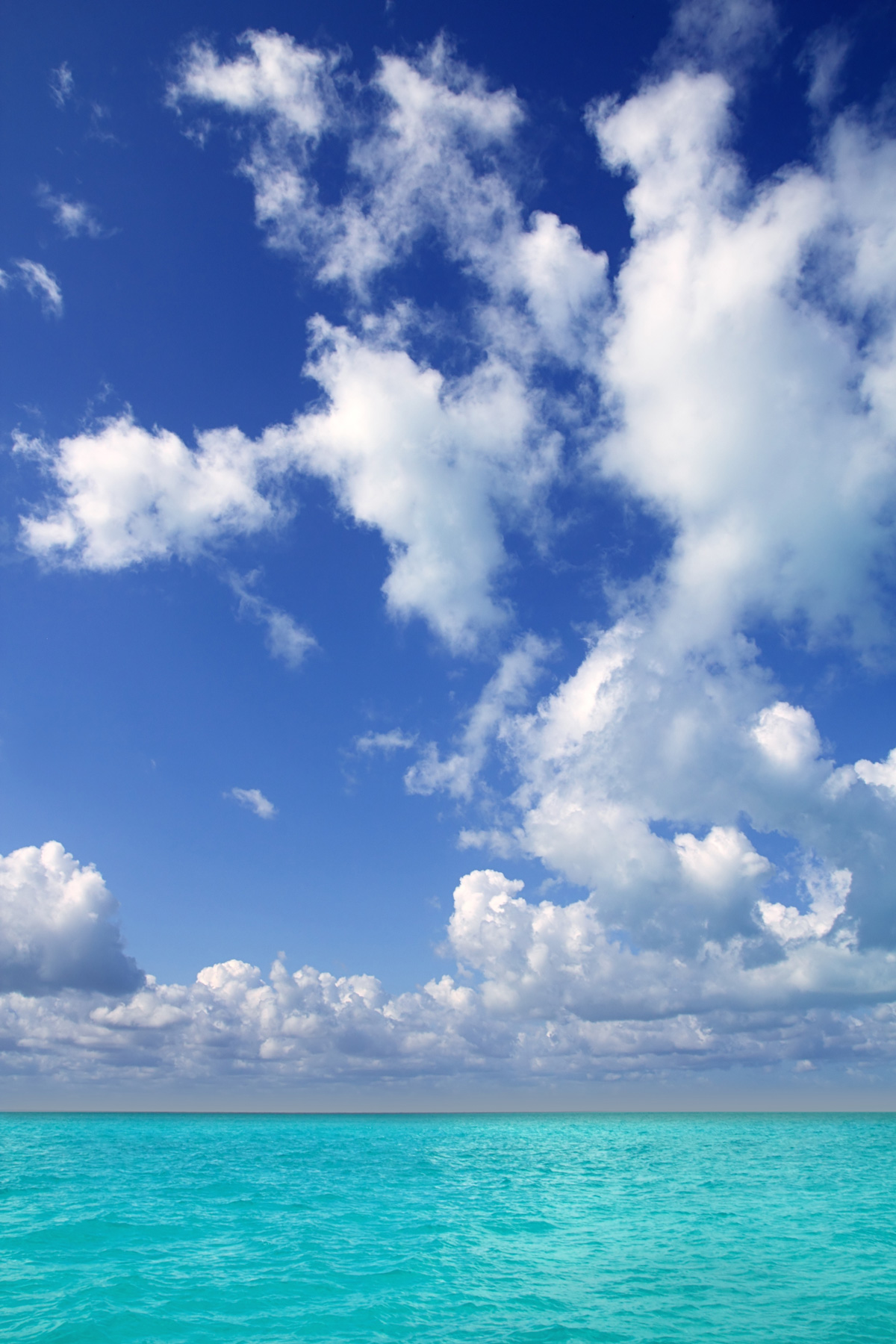 Clouds over a turquoise ocean.