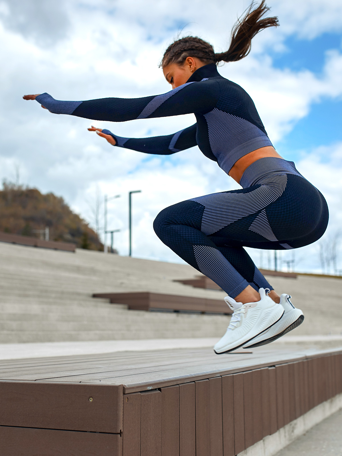 Woman jumping on stairs.